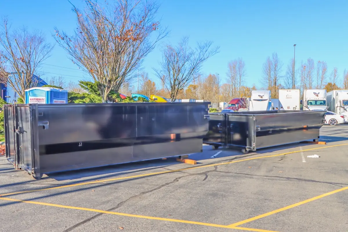 Professional dumpster rental service with roll-off container on residential driveway in Hillsborough